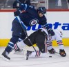 DAVID LIPNOWSKI / WINNIPEG FREE PRESS
Winnipeg Jets Adam Pardy (2) takes down Chicago Blackhawks Marcus Kruger (16) during first period action Sunday at the MTS Centre.