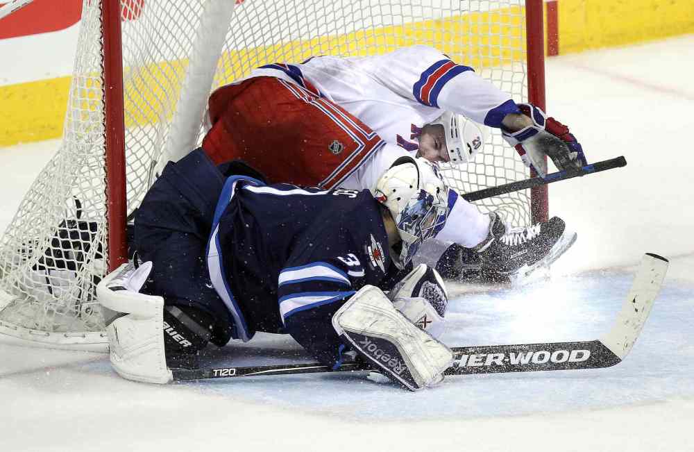 Phil Hossack / Winnipeg Free Press
New York Rangers Chris Kreider and the puck wound up in the net behind Ondrej Pavelec late in the third period, resulting in Kreider's game-winning goal.