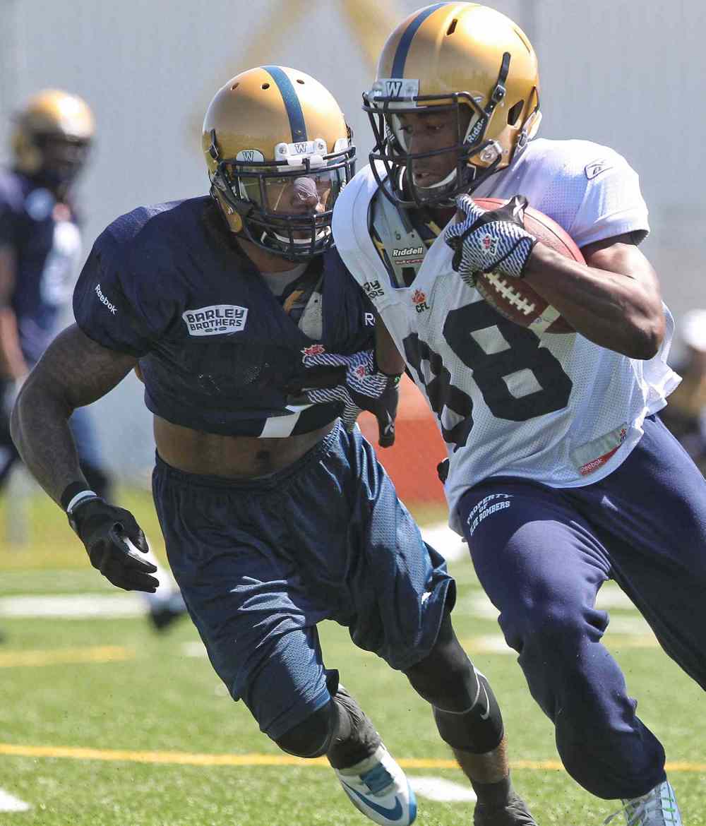 Mike Deal / Winnipeg Free Press
Jhomon Gordon (88) carries the ball while Troy Stoudermire (1) goes for the tackle during the first day of the Winnipeg Blue Bombers training camp Sunday. 150531 May 31, 2015 Mike Deal / Winnipeg Free Press