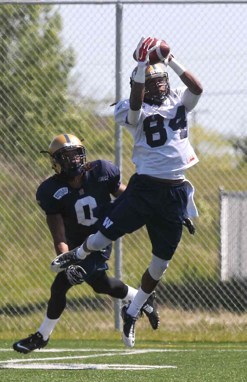 Mike Deal / Winnipeg Free Press
Ja-mes Logan (84) catches the ball in front of Shaq Richardson (0) during the first day of the Winnipeg Blue Bombers training camp Sunday. 150531 May 31, 2015 Mike Deal / Winnipeg Free Press