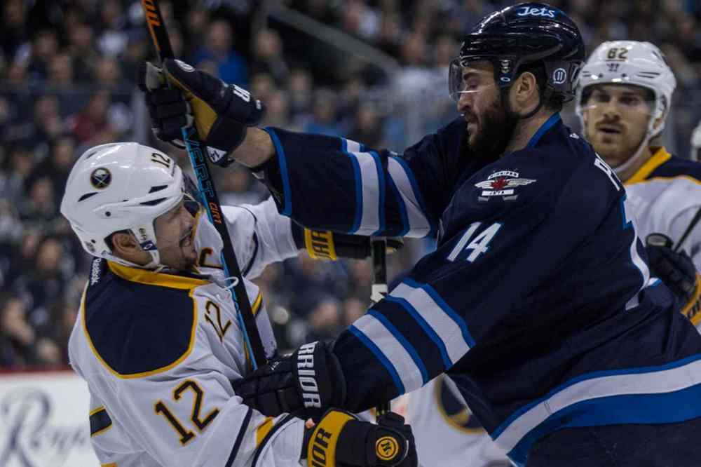 Mike Deal / Winnipeg Free Press
Winnipeg Jets' Anthony Peluso (14) and Buffalo Sabres' Brian Gionta (12) have words after the play during second period.