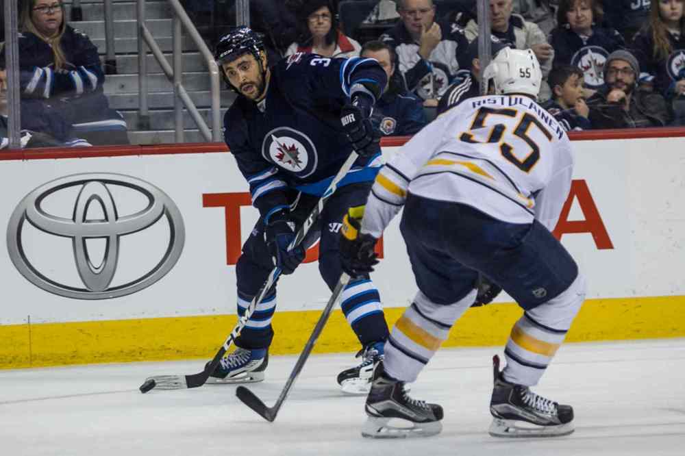 Mike Deal / Winnipeg Free Press
Winnipeg Jets' Dustin Byfuglien (33) and Buffalo Sabres' Rasmus Ristolainen (55) in action during second period.
