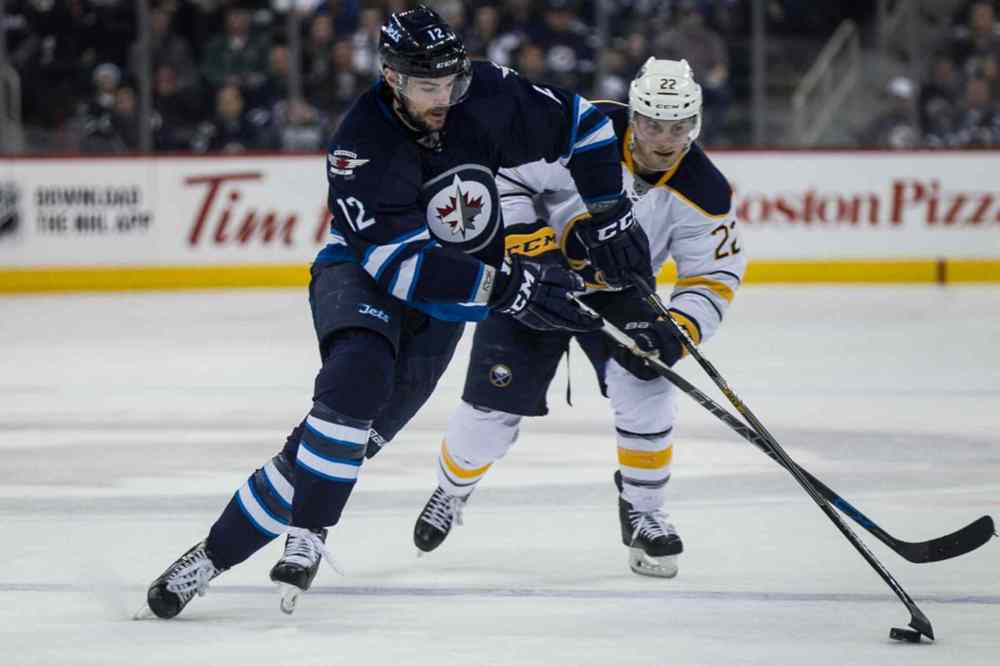 Mike Deal / Winnipeg Free Press
Winnipeg Jets' Drew Stafford (12) on the breakaway past Buffalo Sabres' Johan Larsson (22) during second period.