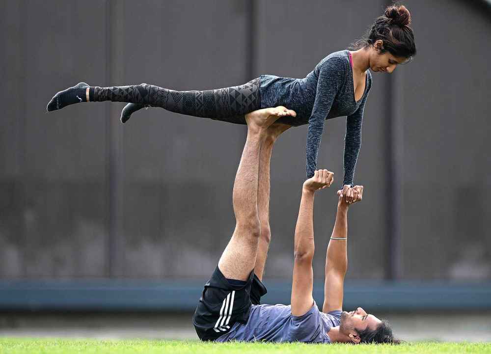 Friends Nicky Rajpul and Amerin Rai train with Acroyoga (a combination of yoga and acobatics) in Assiniboine Park one September afternoon in 2016.