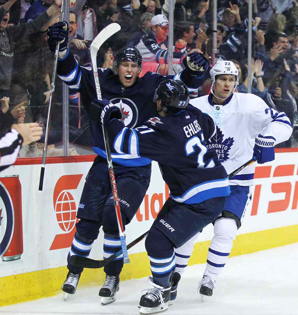MIKE DEAL / WINNIPEG FREE PRESS
Winnipeg Jets Patrik Laine (29) celebrates his overtime hat-trick goal against the Toronto Maple Leafs with Nikolaj Ehlers (27) at the MTS Centre Wednesday evening.
161019
Wednesday, October 19, 2016