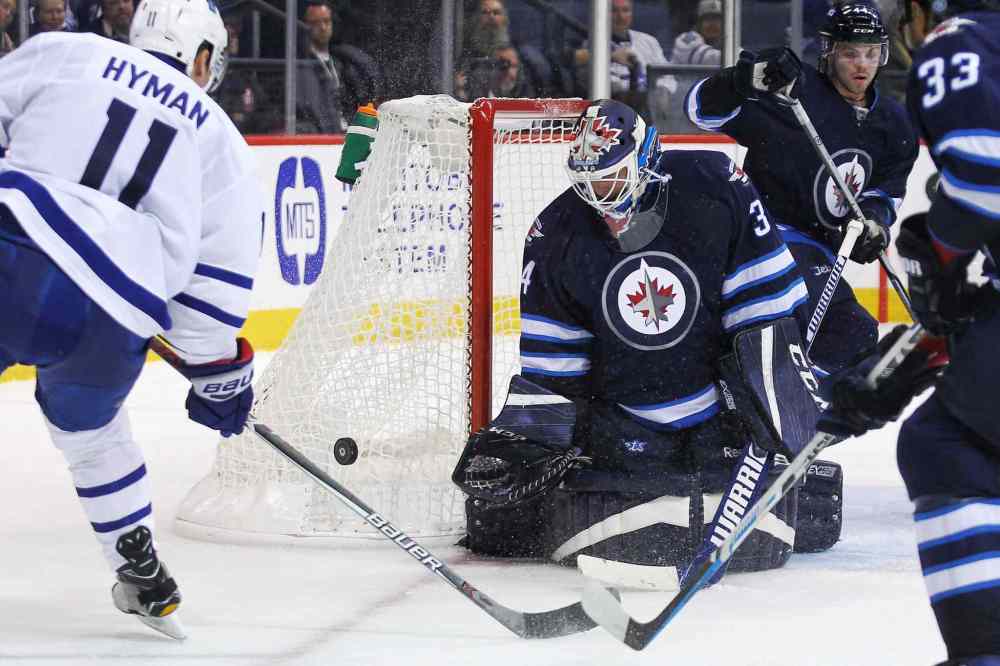 MIKE DEAL / WINNIPEG FREE PRESS
Winnipeg Jets goaltender Michael Hutchinson (34) stops a shot by Toronto Maple Leafs' Zach Hyman (11) during the game at the MTS Centre Wednesday evening.