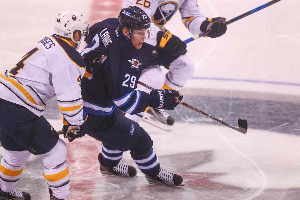 MIKE DEAL / WINNIPEG FREE PRESS
The Winnipeg Jets' Patrik Laine (29) muscles past Buffalo Sabres' defenceman Josh Gorges (#4) during Sunday's game at the MTS Centre.