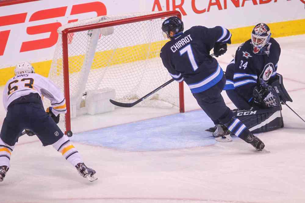 MIKE DEAL / WINNIPEG FREE PRESS
Winnipeg Jets' goaltender Michael Hutchinson (34) watches as the puck flies in front of the net while Buffalo Sabres' forward Tyler Ennis (#63) tries to slap it in and Winnipeg Jets' Ben Chiarot (7) goes for the block.