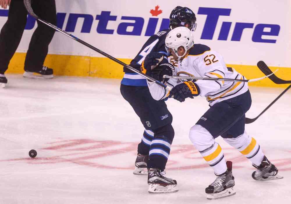 MIKE DEAL / WINNIPEG FREE PRESS
Winnipeg Jets' Josh Morrissey (44) slows down Buffalo Sabres' forward Hudson Fasching (#52).
