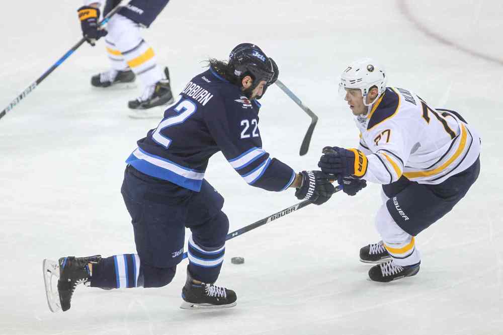 MIKE DEAL / WINNIPEG FREE PRESS
Winnipeg Jets' Chris Thorburn (22) tries to manoeuvre around Buffalo Sabres' defenceman Dmitry Kulikov (#77) during Sunday's game.