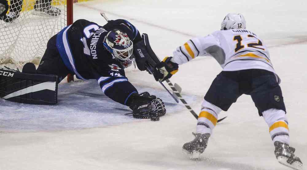 MIKE DEAL / WINNIPEG FREE PRESS
Winnipeg Jets' goaltender Michael Hutchinson (34) tries to stop the puck while Buffalo Sabres' forward Brian Gionta (#12) goes in to slap it into the net during Sunday's game.