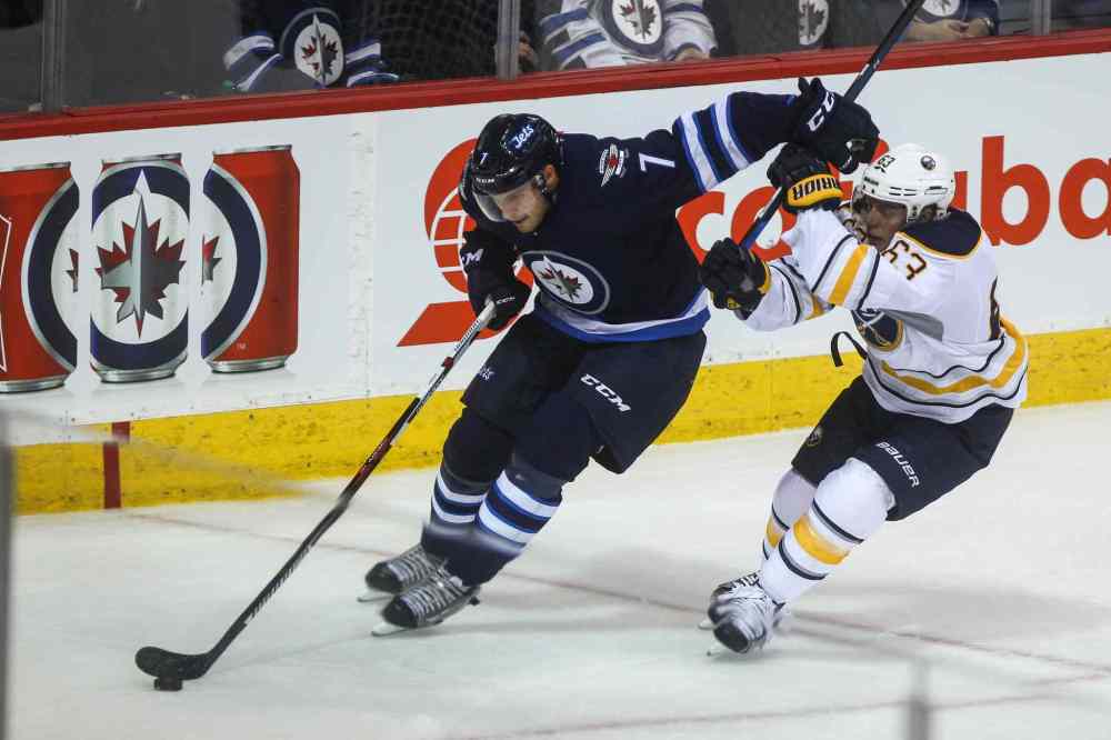 MIKE DEAL / WINNIPEG FREE PRESS
Winnipeg Jets' Ben Chiarot (7) keeps Buffalo Sabres' forward Tyler Ennis (#63) off the puck.