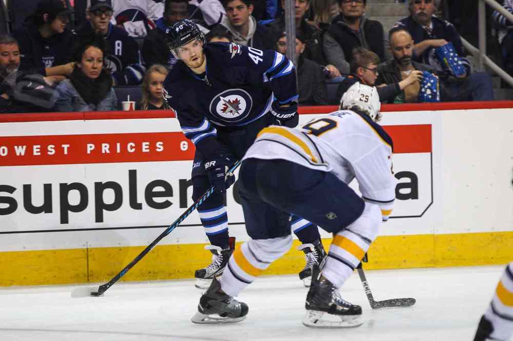 MIKE DEAL / WINNIPEG FREE PRESS
Winnipeg Jets' Joel Armia (40) looks to pass the puck past Buffalo Sabres' defenceman Jake McCabe (#29).