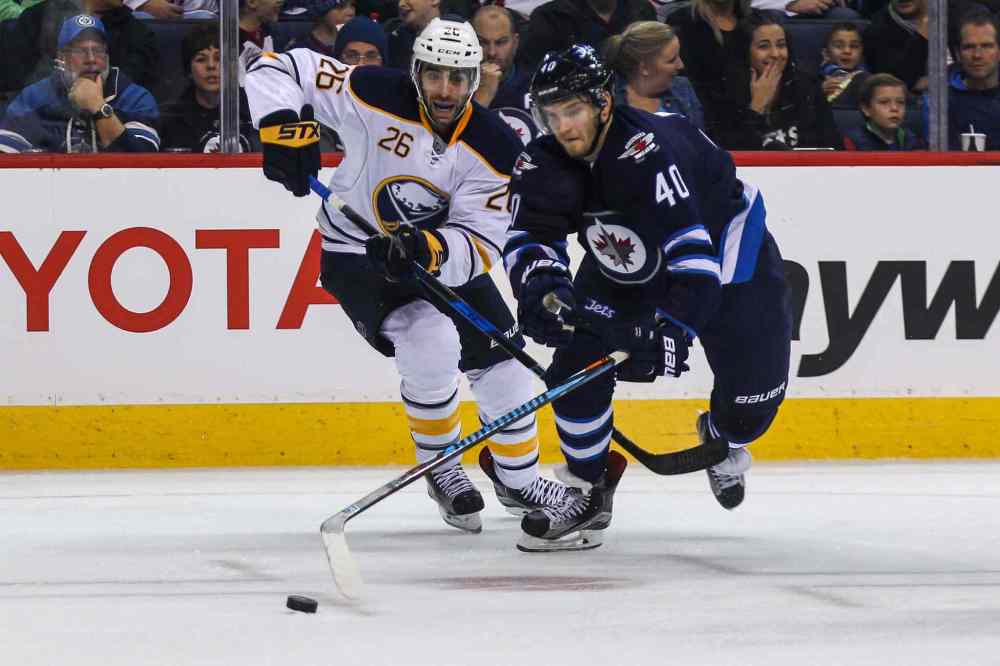 MIKE DEAL / WINNIPEG FREE PRESS
Winnipeg Jets' Joel Armia (40) tries to keep the puck while Buffalo Sabres' forward Matt Moulson (#26) chases after it.