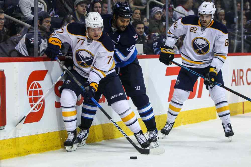 MIKE DEAL / WINNIPEG FREE PRESS
Winnipeg Jets' Dustin Byfuglien (33) is forced off the puck by Buffalo Sabres' defenceman Dmitry Kulikov (#77).