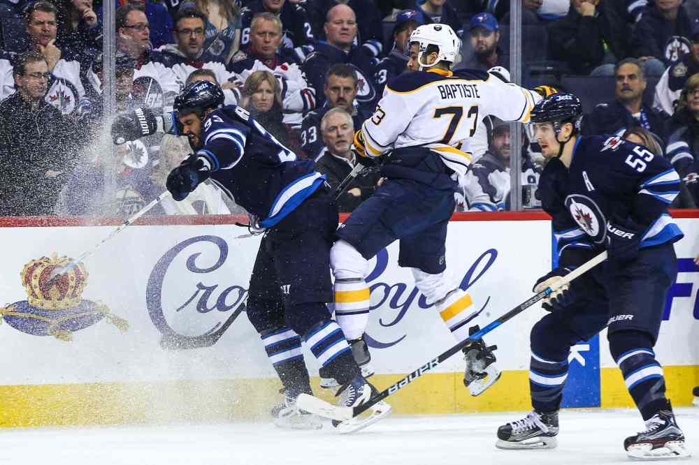 MIKE DEAL / WINNIPEG FREE PRESS
Winnipeg Jets' Dustin Byfuglien (33) knocks Buffalo Sabres' forward Nicholas Baptiste (#73) off the puck.