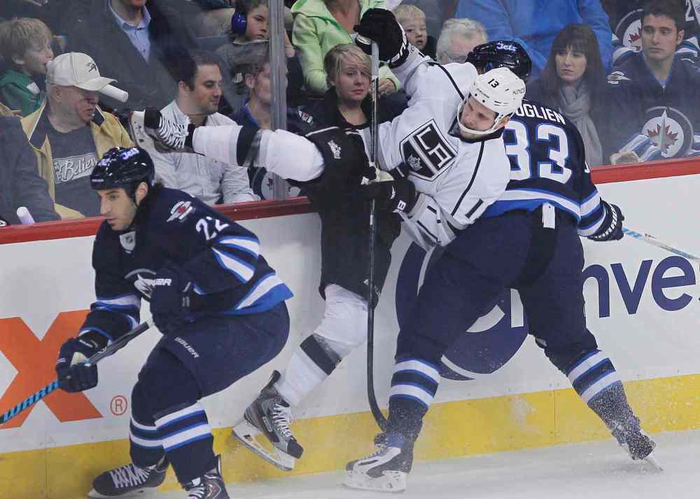 JOHN WOODS / THE CANADIAN PRESS
Winnipeg Jets' Dustin Byfuglien (33) takes out Los Angeles Kings' Kyle Clifford (13) as Jets' Chris Thorburn (22) chases down the puck during the first period.