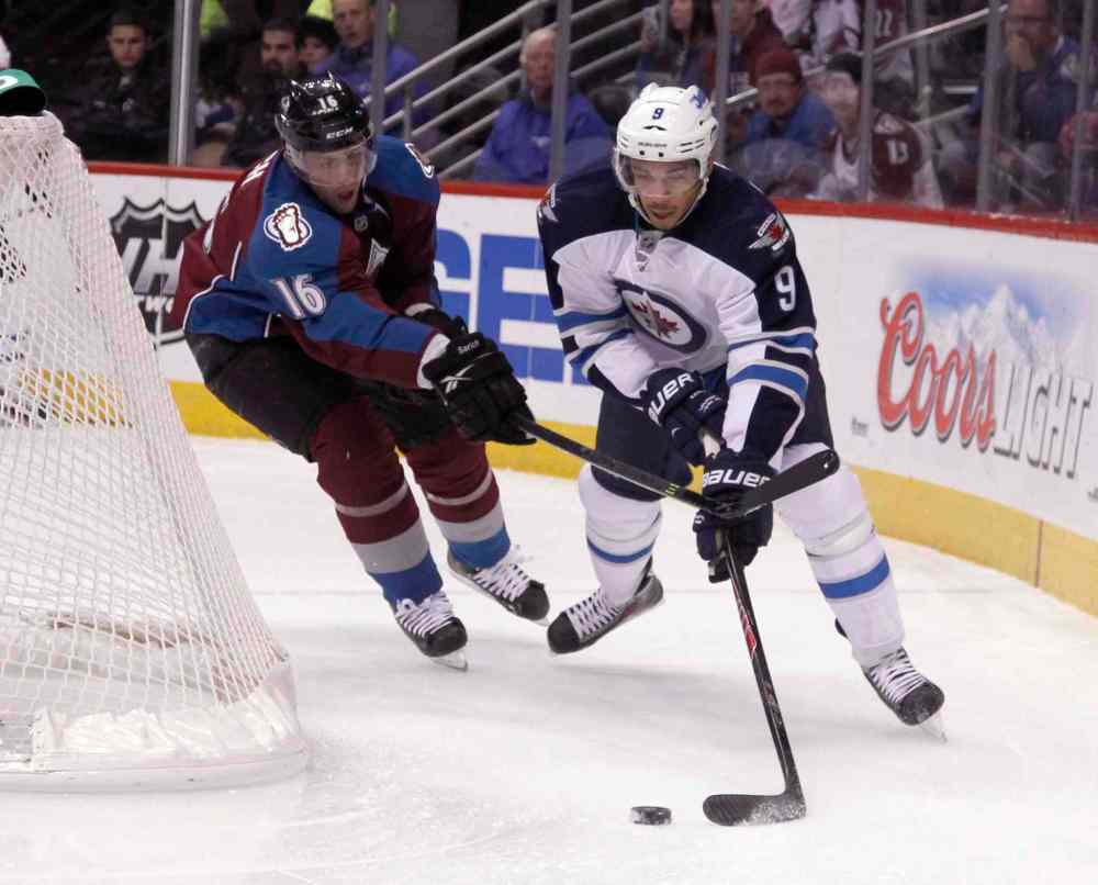 David Zalubowski / The Associated Press
Evander Kane tries a wraparound as Avalanche defenceman Cory Sarich gives chase in the first period.