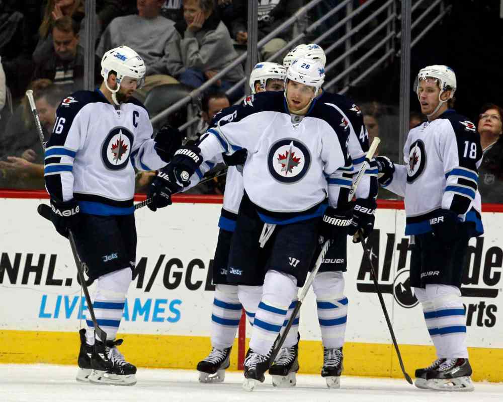 David Zalubowski / The Associated Press
Blake Wheeler (centre) celebrates his power play goal with Andrew Ladd (left) and centre Bryan Little (right) in eth second period.