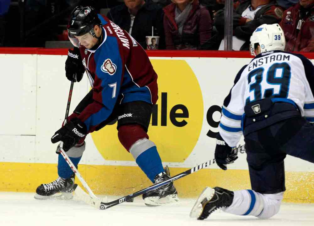 David Zalubowski / The Associated Press
Colorado Avalanche center John Mitchell (left) has his stick break while trying to clear the puck along the boards as he battles with Tobias Enstrom in the second period.