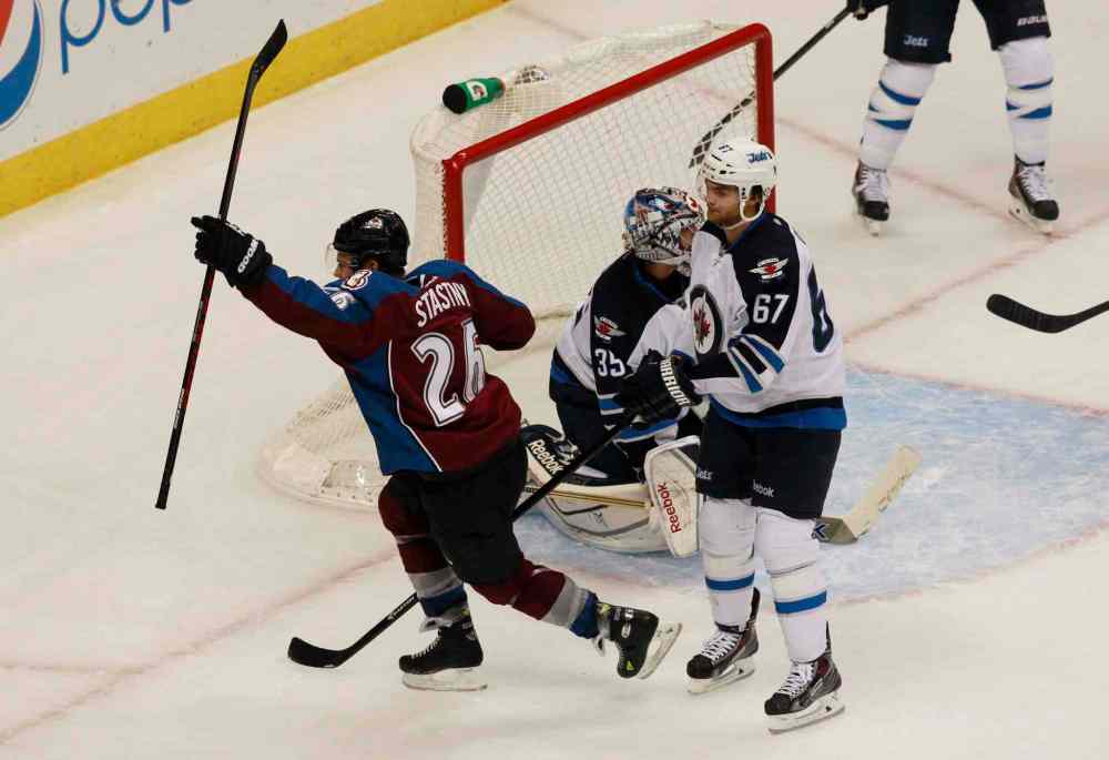 David Zalubowski / The Associated Press
Colorado Avalanche center Paul Stastny (left) celebrates after scoring the scoring the game-winning goal as Al Montoya (centre) and winger Michael Froliklook on in the third period.