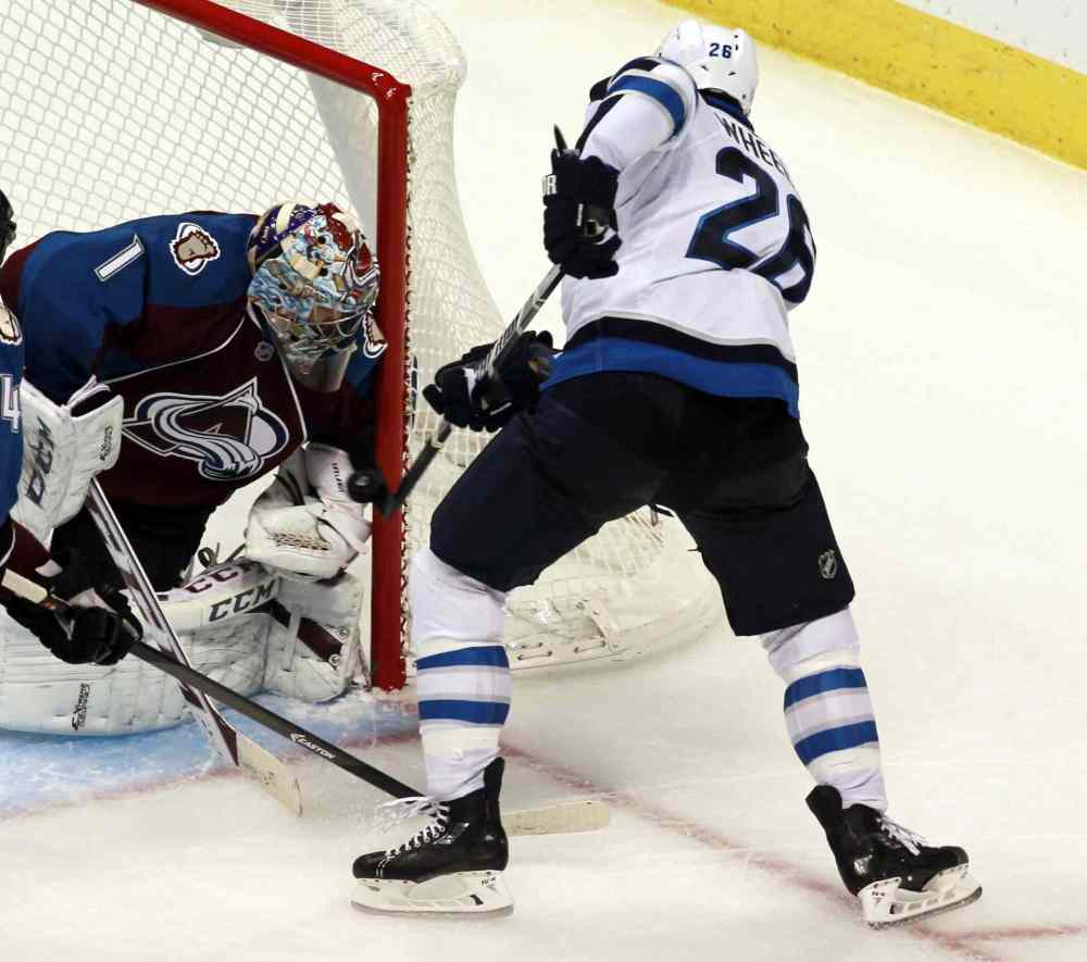 David Zalubowski / The Associated Press
Colorado Avalanche goalie Semyon Varlamov stops a Blake Wheeler shot in the third period.