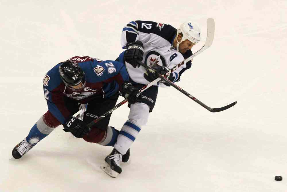 David Zalubowski / The Associated Press
Gabriel Landeskog (left) gets tangled up with Olli Jokinen while pursuing the puck in the third period.