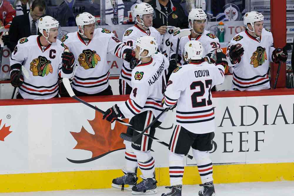 John Woods / The Canadian Press
Members of the Chicago Blackhawks celebrate the first-period goal by Niklas Hjalmarsson (bottom left).