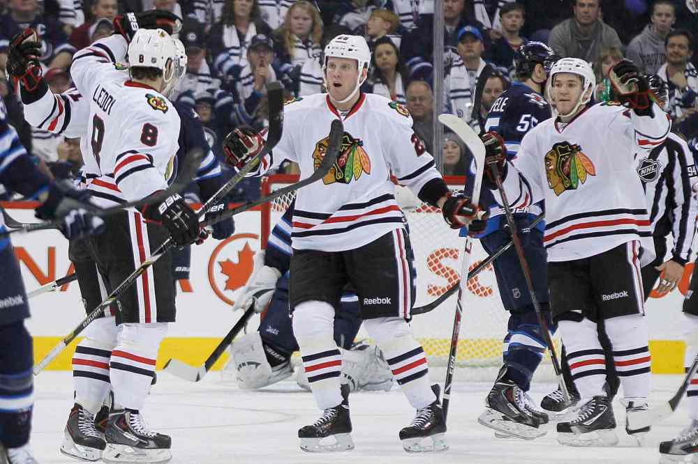 John Woods / The Canadian Press
Chicago Blackhawks' Bryan Bickell (centre) and Andrew Shaw (right) celebrate Nick Leddy's goal against the Winnipeg Jets during the second period.
