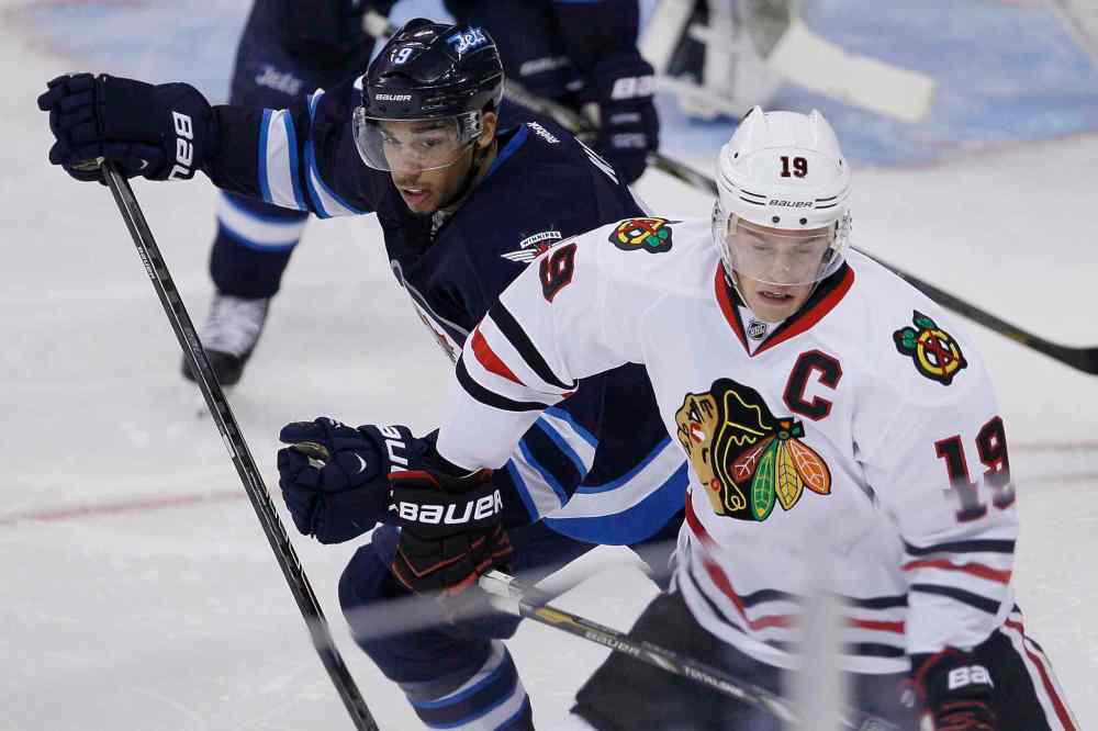 John Woods / The Canadian Press
Evander Kane (9) and Jonathan Toews (19) jostle for position during the third period.