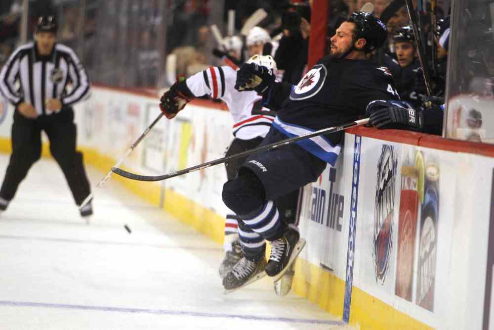 Ruth Bonneville / Winnipeg Free Press
Zach Bogosian gets shoved into the boards.