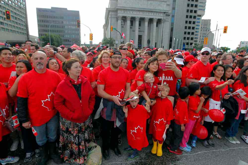 BORIS MINKEVICH / WINNIPEG FREE PRESS
3,600 proud Winnipeggers joined together bright and early at Portage & Main to create a human flag celebrating Canada Day.