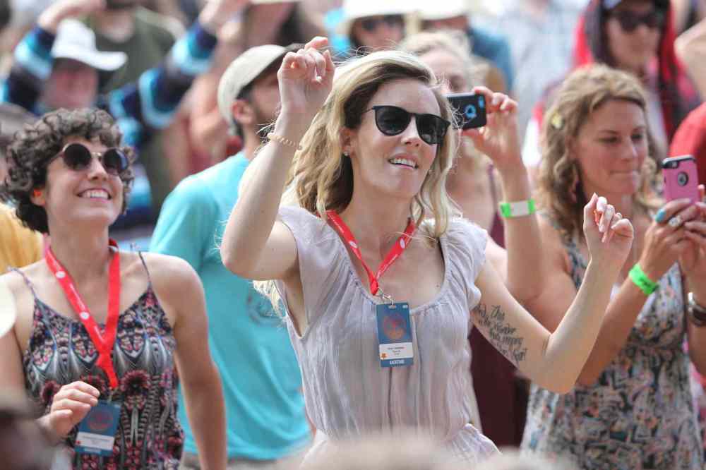 RUTH BONNEVILLE / WINNIPEG FREE PRESS
Tara Taronno dances with thousands of others as they listen to the performers on stage at the 44th annual Folk Festival at Birds Hill Park Saturday.