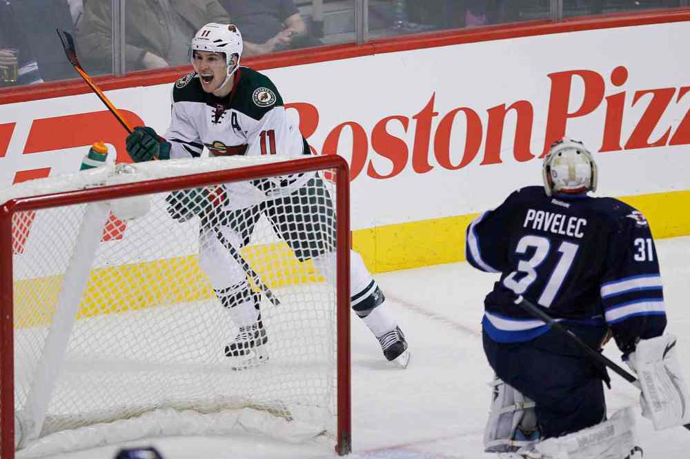 JOHN WOODS / THE CANADIAN PRESS
Minnesota Wild's Zach Parise (top) celebrates his goal against Winnipeg Jets goaltender Ondrej Pavelec during the third period.
