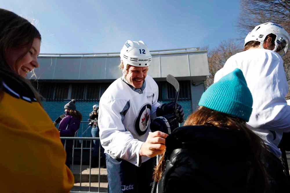 Jason DeCrow / The Associated Press
Olli Jokinen signs autographs for a pair of young fans.