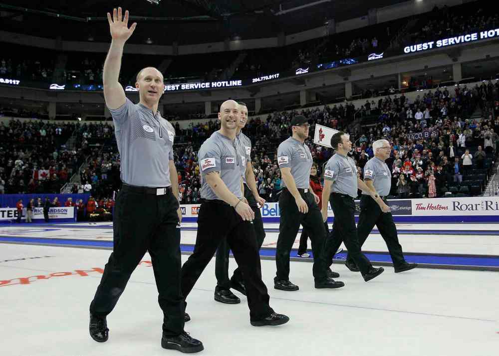 John Woods / The Canadian Press
Skip Brad Jacobs (left) and his team acknowledge the crowd as they make their way down the ice after winning the final.