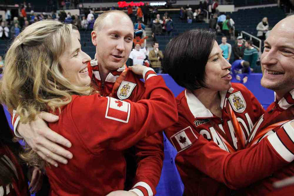 John Woods / The Canadian Press
Brad Jacobs (centre left) and Ryan Fry (right) are congratulated by women's winners Jennifer Jones (left) and Jill Officer.