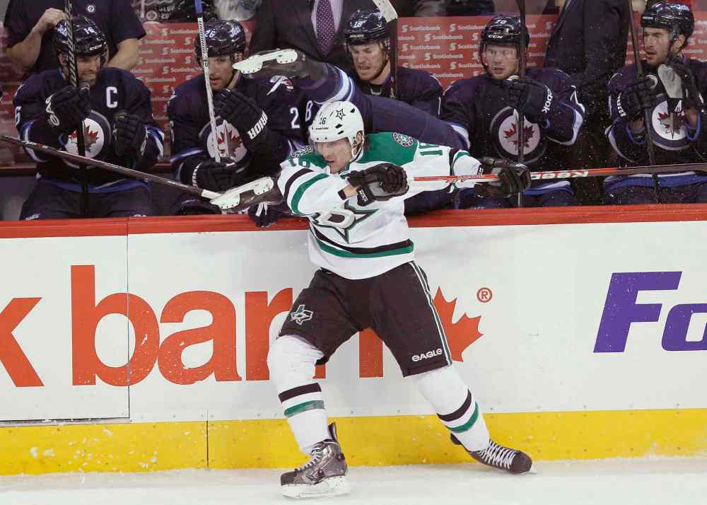 JOHN WOODS / THE CANADIAN PRESS
Ryan Garbutt (bottom) of the Dallas Stars checks Mark Scheifele of the Winnipeg Jets over the boards during the first period.