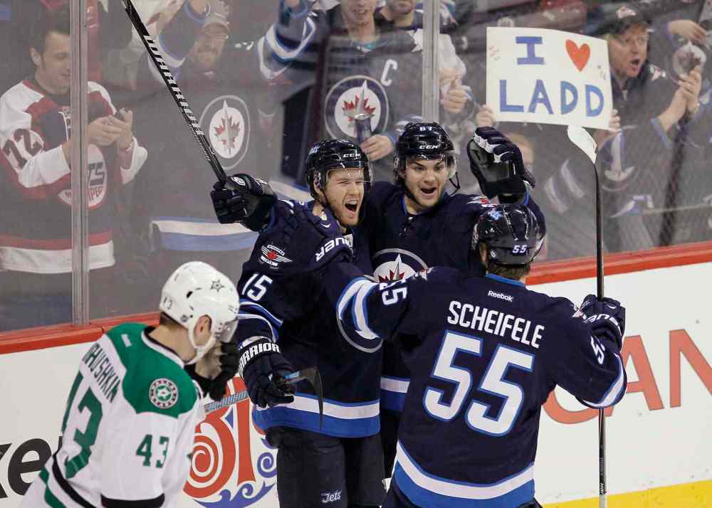 JOHN WOODS / THE CANADIAN PRESS
Matt Halischuk (centre left), Michael Frolik (centre right) and Mark Scheifele (right) celebrate Halischuk's first-period goal as Dallas Stars forward Valeri Nichushkin skates.