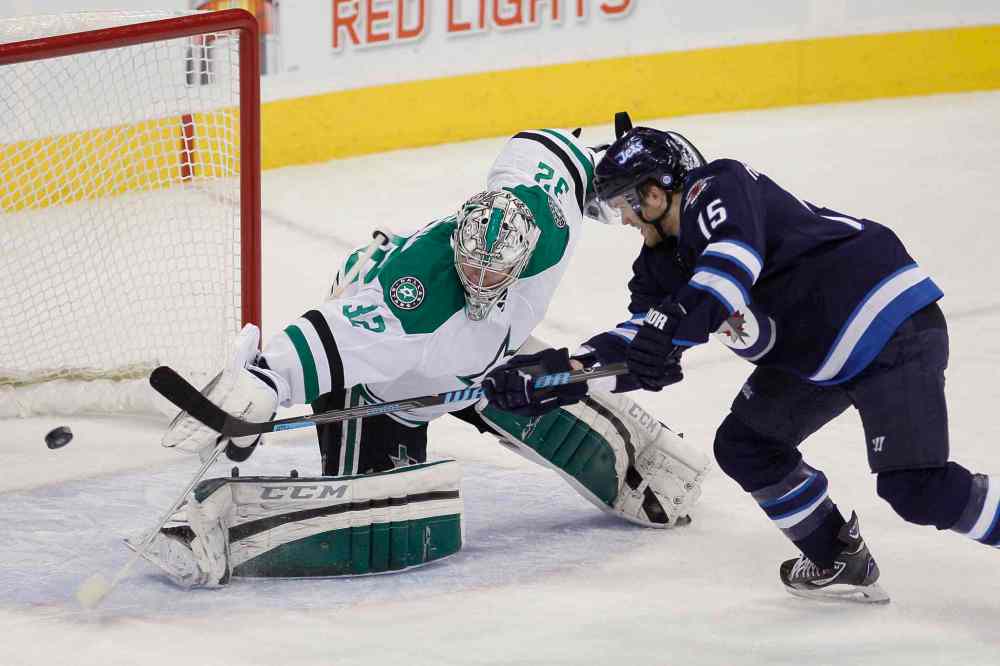 JOHN WOODS / THE CANADIAN PRESS
Winnipeg Jets forward Matt Halischuk (right) scores on Dallas Stars goaltender Kari Lehtonen during the first period.