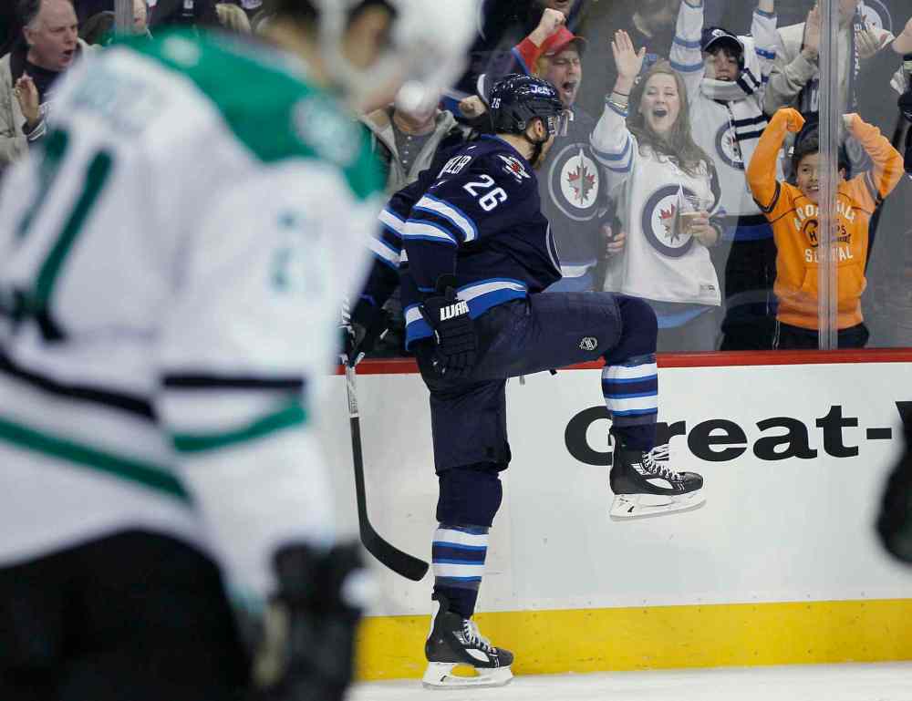 JOHN WOODS / THE CANADIAN PRESS
Blake Wheeler (right) celebrates his second goal against the Dallas Stars as Antoine Roussel skates by during the second period.