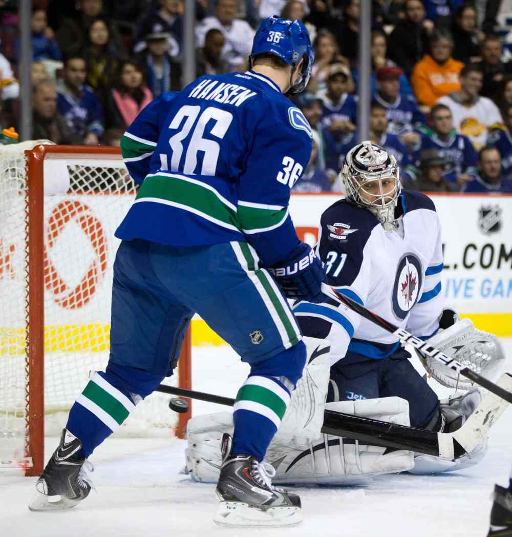 DARRYL DYCK / THE CANADIAN PRESS
Winnipeg Jets goalie Ondrej Pavelec (right) lets in a shot by Brad Richardson (not shown) as Jannik Hansen watches.