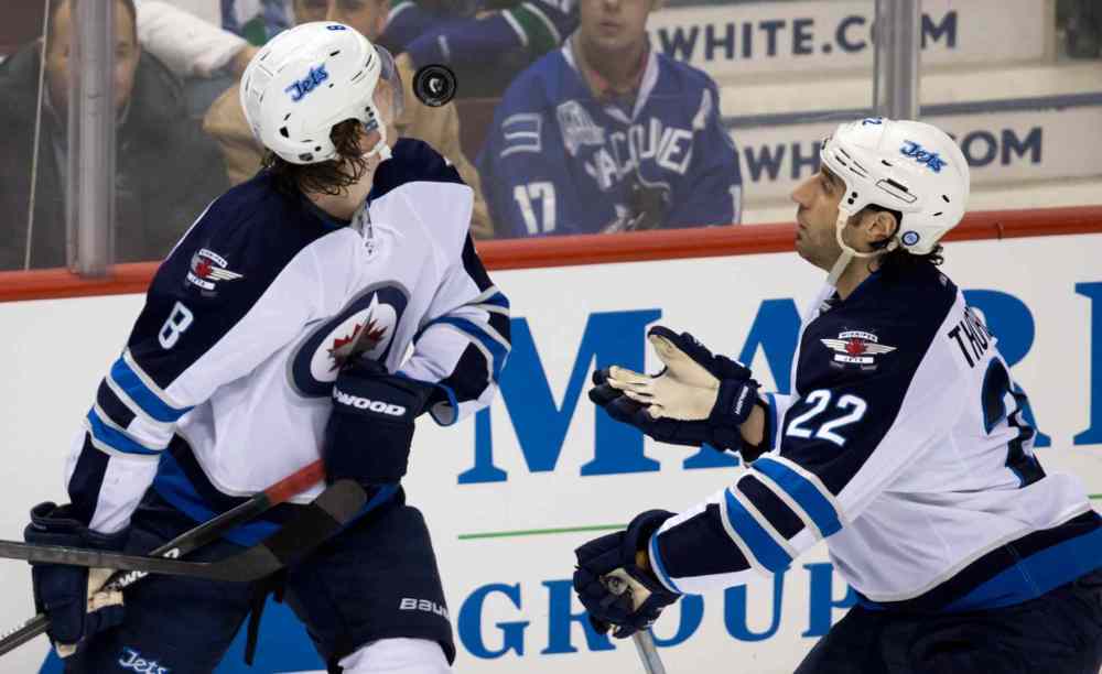 DARRYL DYCK / THE CANADIAN PRESS
Winnipeg Jets defenceman Jacob Trouba (left) and Chris Thorburn watch an airborne puck during the second period.