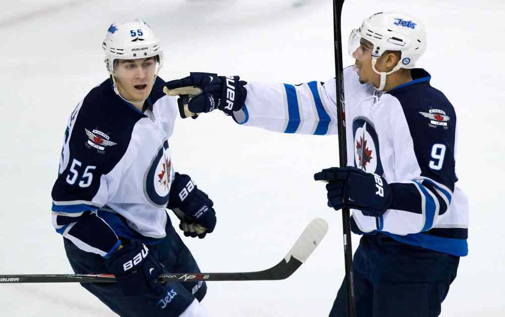 DARRYL DYCK / THE CANADIAN PRESS
Winnipeg Jets forward Evander Kane (right) and Mark Scheifele celebrate Kane's goal against the Vancouver Canucks during the second period.