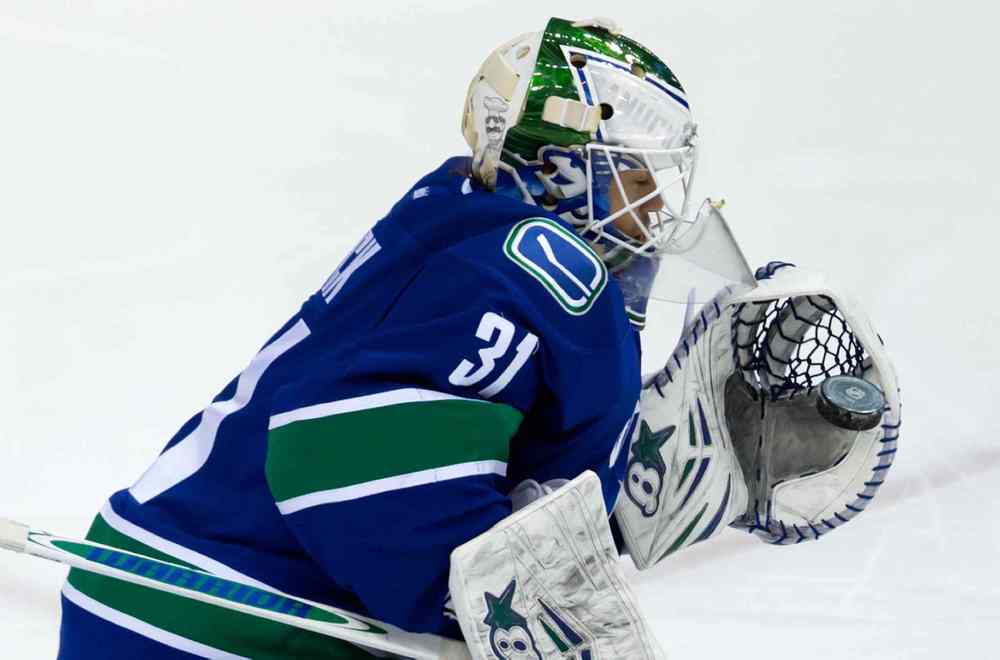 DARRYL DYCK / THE CANADIAN PRESS
Vancouver Canucks goalie Eddie Lack makes a glove save against the Winnipeg Jets during the second period.