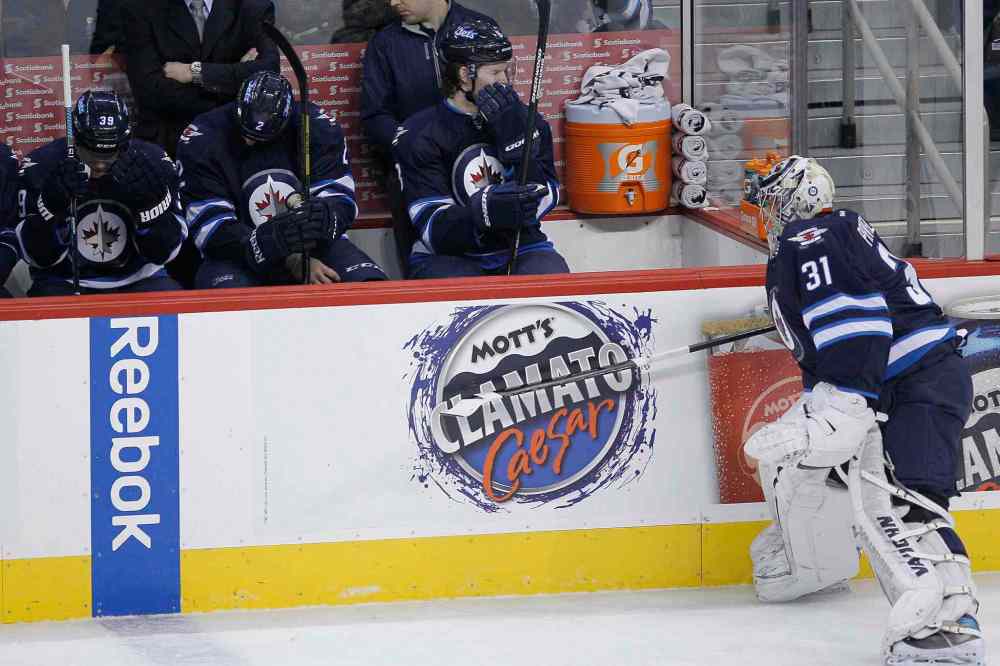 JOHN WOODS / THE CANADIAN PRESS
Winnipeg Jets goaltender Ondrej Pavelec (right) slams his stick against the boards in anger after being pulled during the first period.