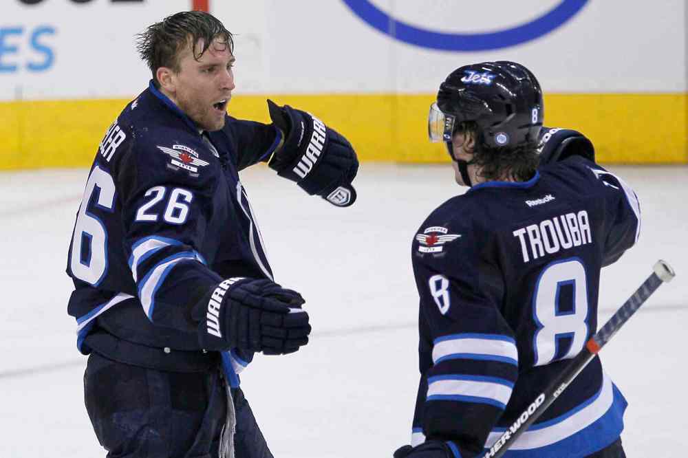 JOHN WOODS / THE CANADIAN PRESS
Winnipeg Jets forward Blake Wheeler (left) and defenceman Jacob Trouba celebrate Wheeler's goal against the Minnesota Wild during the third period.