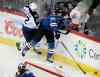 Joe Mahoney / The Associated Press
Winnipeg Jets winger Chris Thorburn (left) checks Colorado Avalanche defenceman Ryan Wilson during the first period.