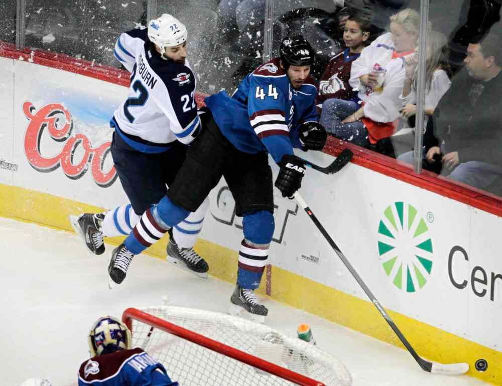Joe Mahoney / The Associated Press
Winnipeg Jets winger Chris Thorburn (left) checks Colorado Avalanche defenceman Ryan Wilson during the first period.