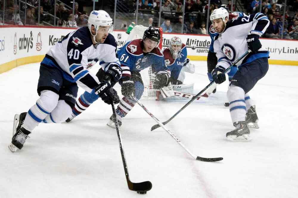 Joe Mahoney / The Associated Press
Winnipeg Jets winger Devin Setoguchi (left) carries the puck along the boards as Colorado Avalanche defenceman Andre Benoit (61) gives chase and Jets winger Chris Thorburn (right) and Avalanche goalie Semyon Varlamov watch.